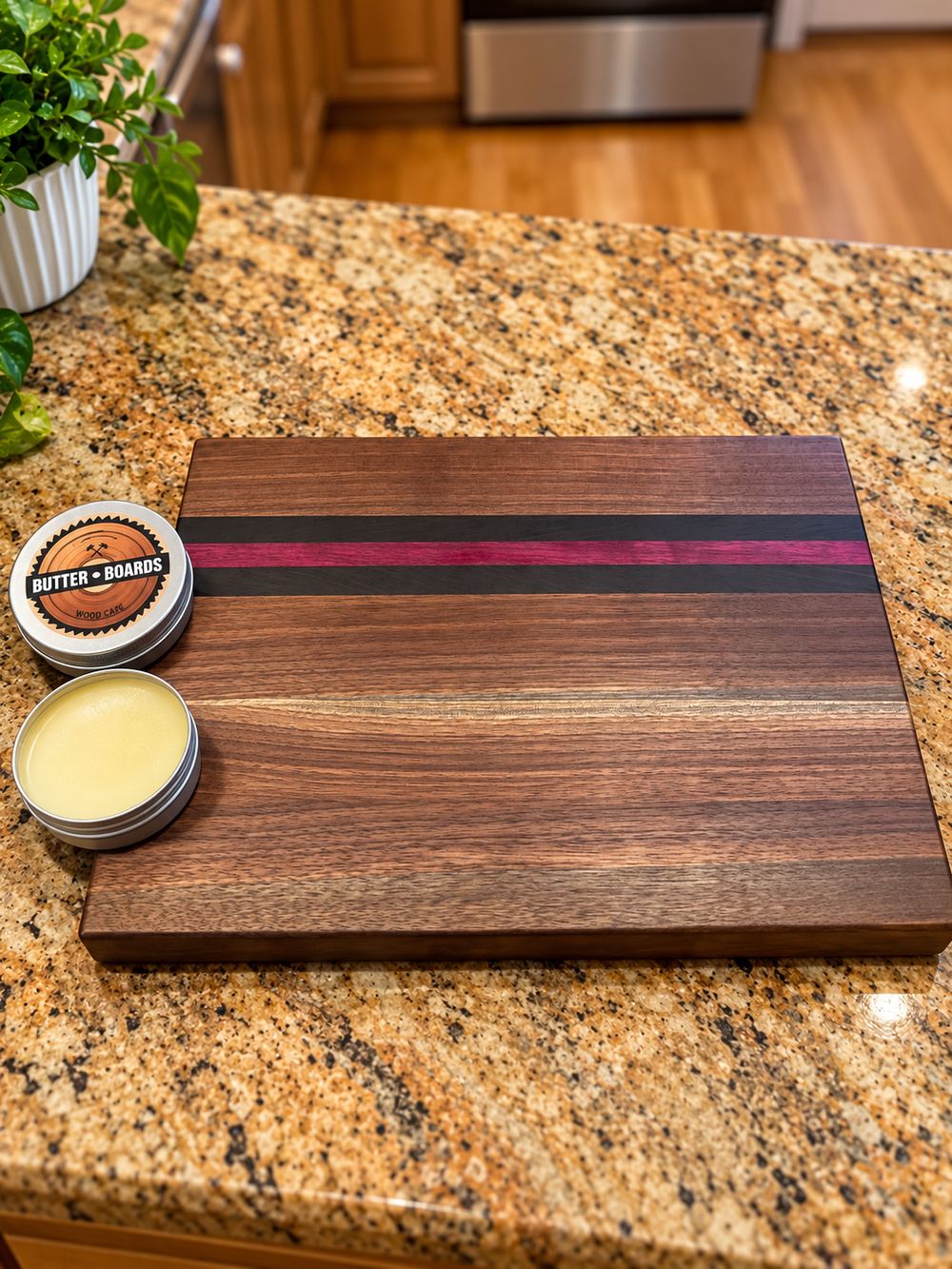 Walnut board next to a tin of board butter